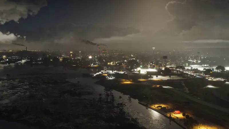 Ambrosia at night from above, refinery lights in the distance