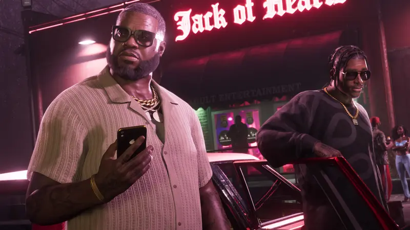 Boobie Ike on his phone outside the Jack of Hearts club, Dre'Quan Priest behind him