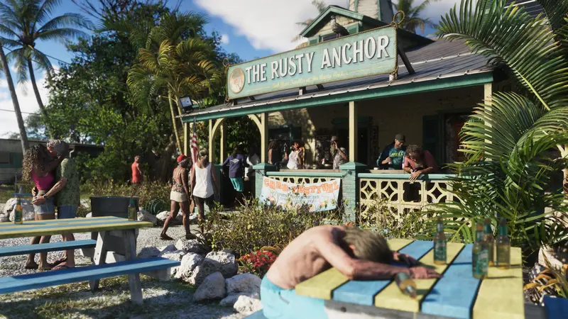 Outside The Rusty Anchor bar, a Crab Festival banner on the porch and a man passed out at a picnic table