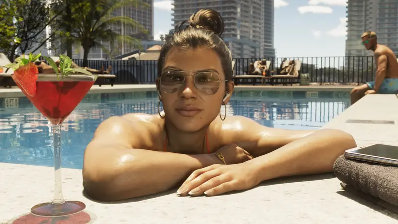 Lucia Caminos at the edge of a pool in sunglasses, a cocktail beside her