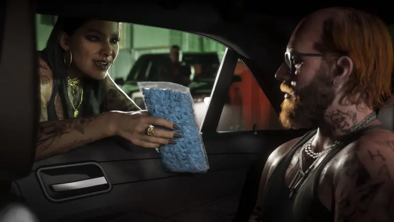 A woman in a car holds up a bag of blue pills