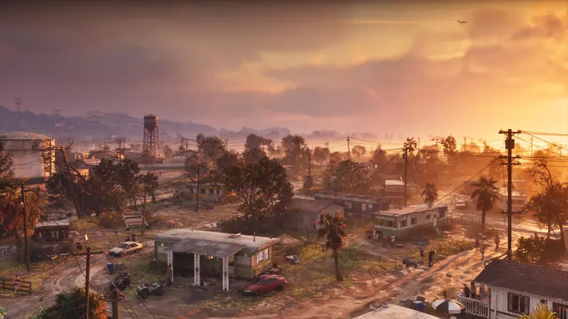 A run-down neighborhood at sunset, a water tower on the skyline