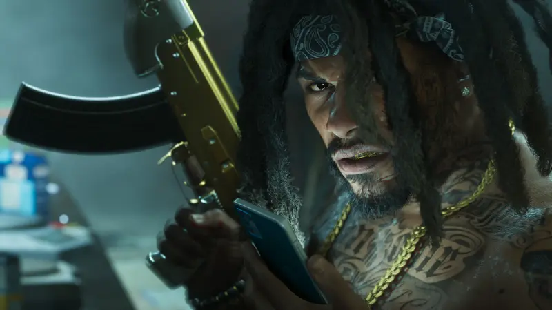 A man with dreadlocks holds a gold rifle and a phone